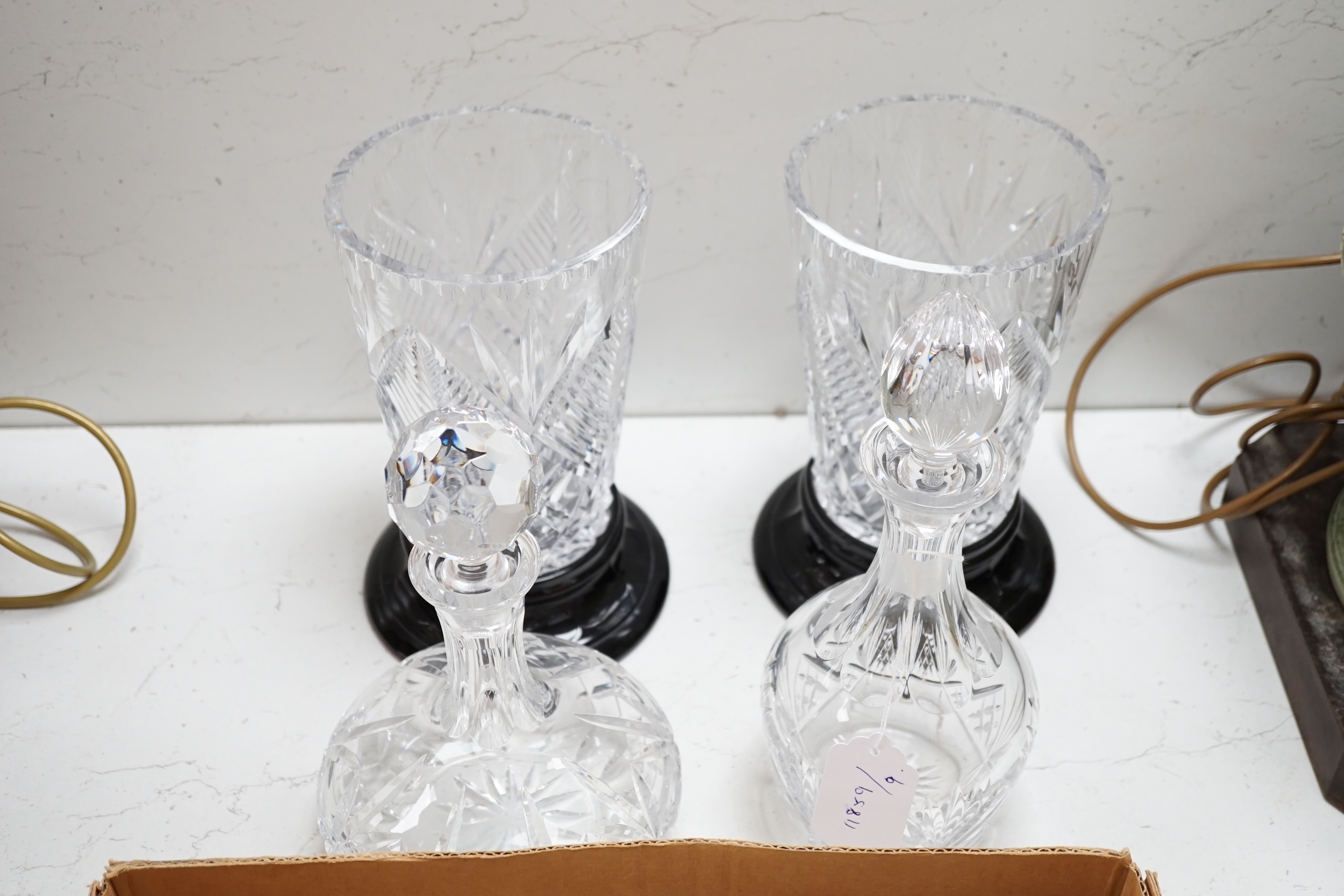 A pair of cut glass vases on stands two decanters and a collection of small glass bottles and silver plate etc., vases 24.5cm